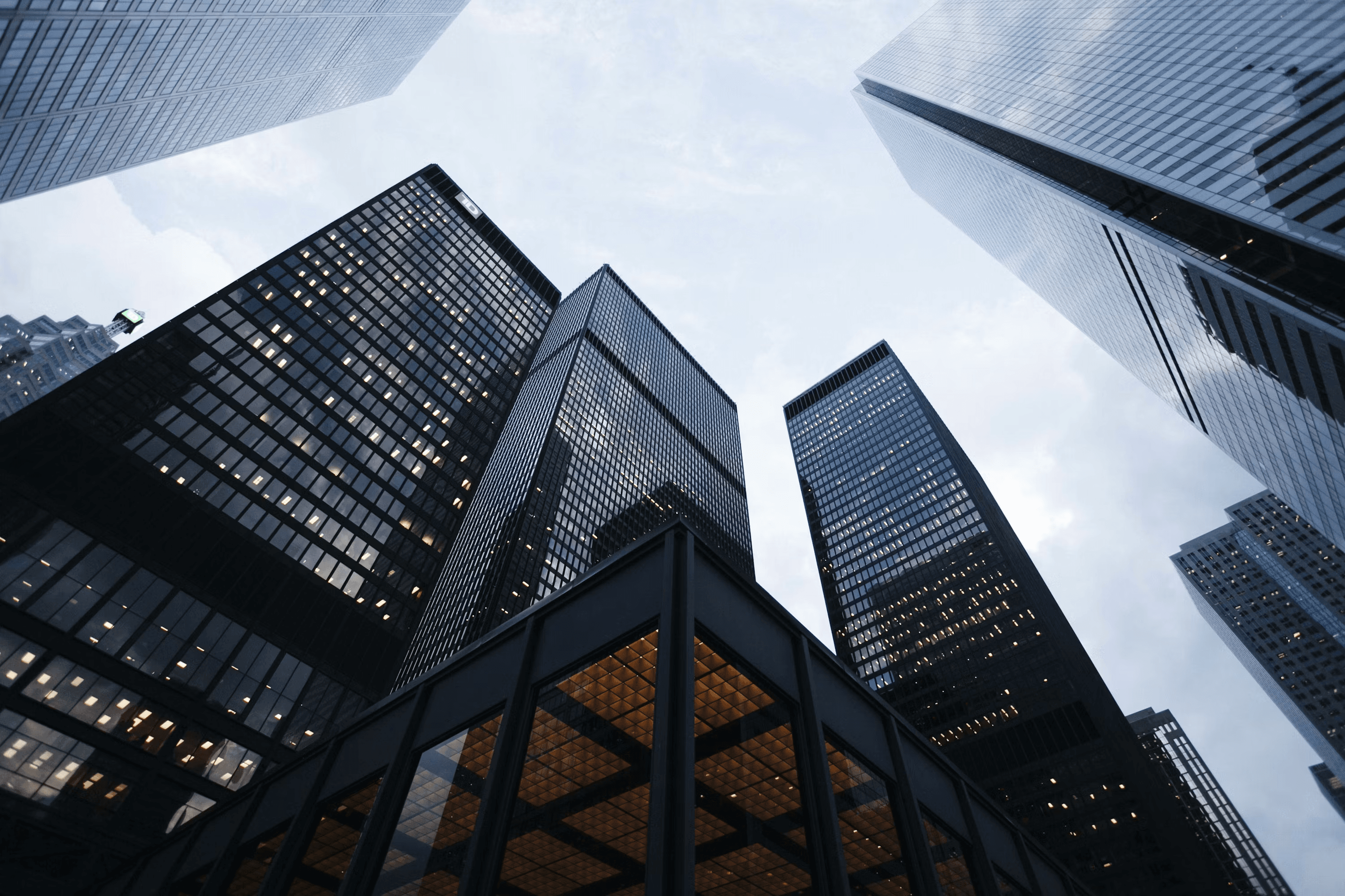 Looking up at a cluster of glass office towers