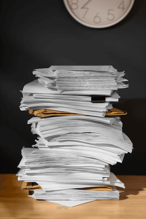 A tall stack of paper applications