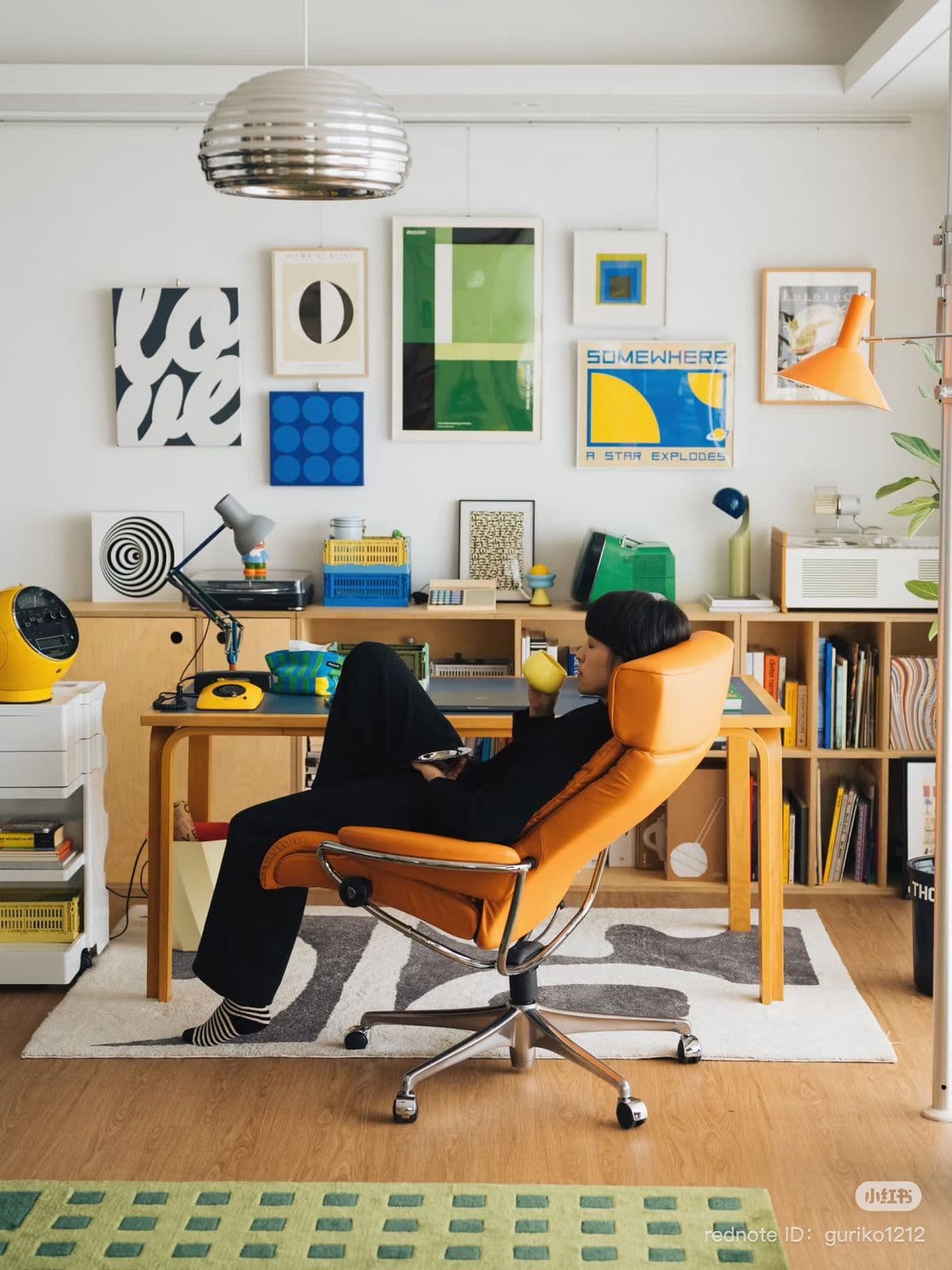 A person taking a quiet pause in an expressive creative workspace