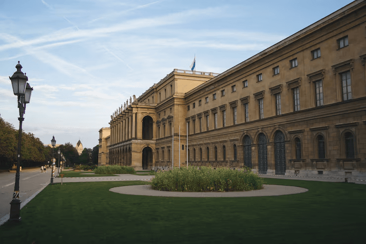 A grand college building with a landscaped lawn